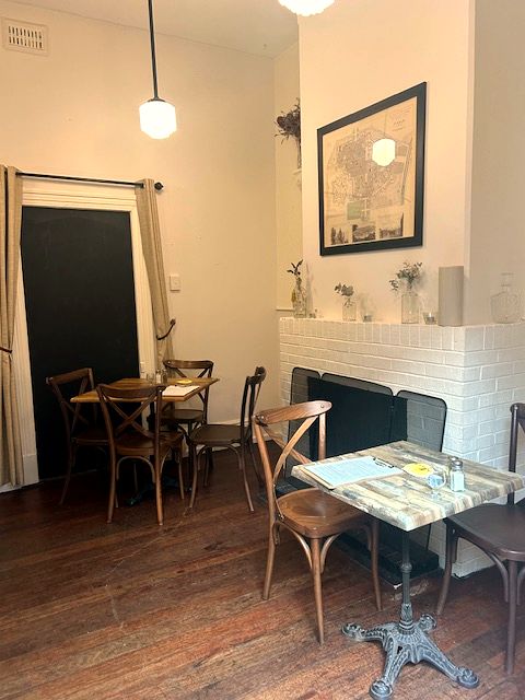 A cosy nook by the fireplace, set for a group
